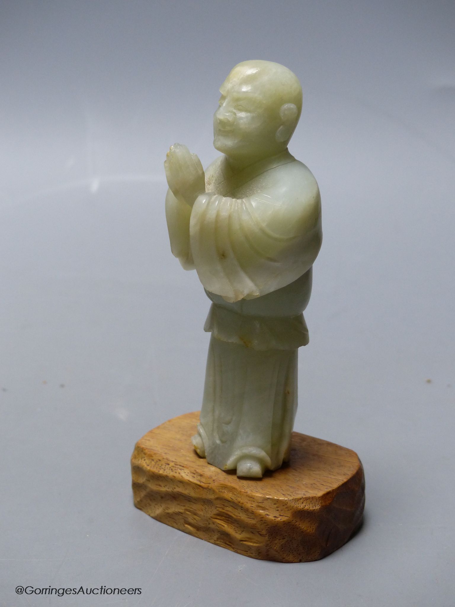 A Chinese celadon jade figure of a priest
